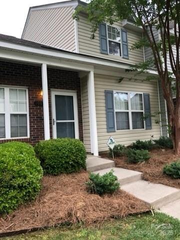 property entrance featuring brick siding