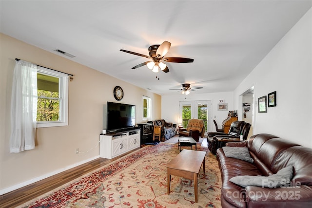 living room with ceiling fan, light hardwood / wood-style flooring, and french doors