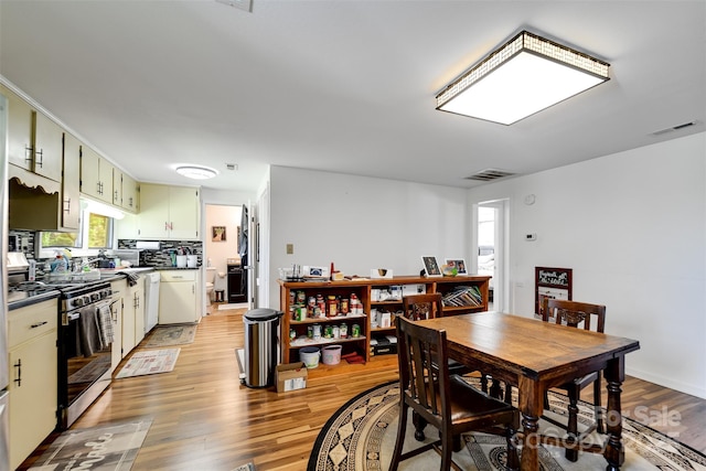 dining space with light hardwood / wood-style floors