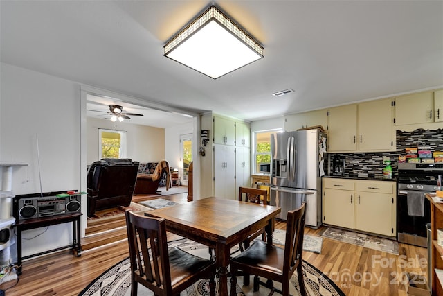 dining area with ceiling fan and light wood-type flooring