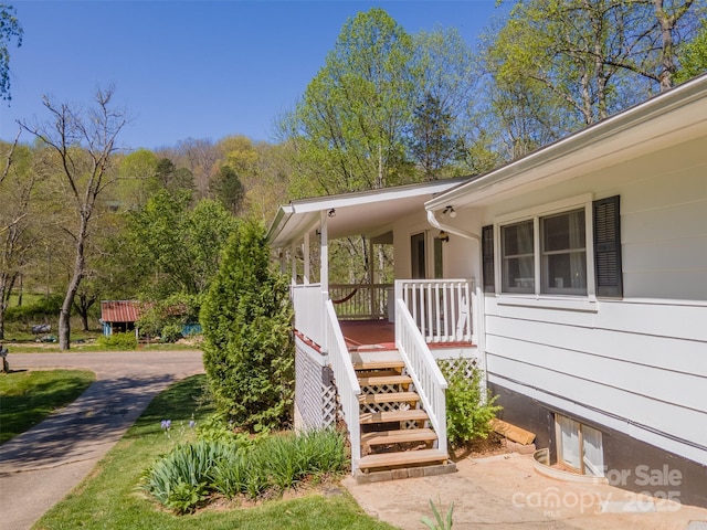 view of exterior entry with a porch