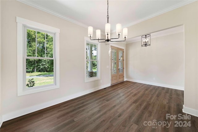 unfurnished dining area with french doors, crown molding, dark wood-type flooring, and a notable chandelier