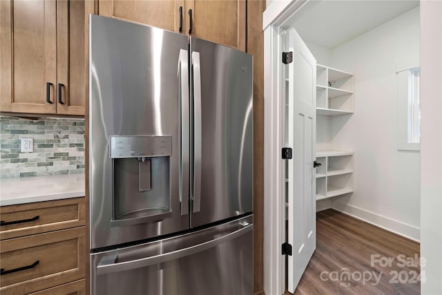 kitchen featuring tasteful backsplash, stainless steel fridge with ice dispenser, and dark wood-type flooring