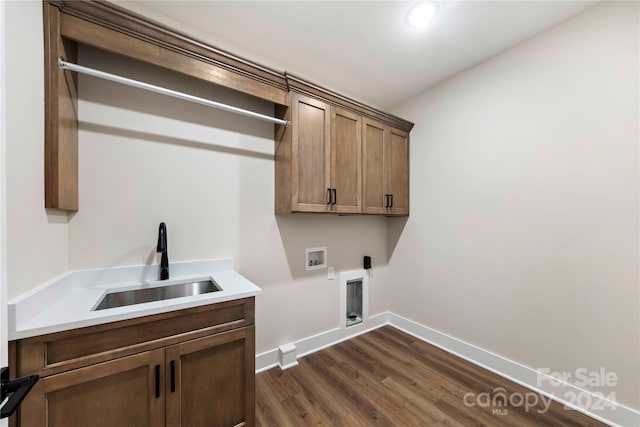 clothes washing area featuring cabinets, sink, hookup for a washing machine, dark hardwood / wood-style floors, and hookup for an electric dryer