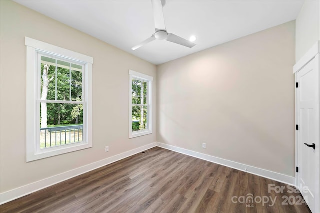 spare room featuring ceiling fan and dark hardwood / wood-style floors