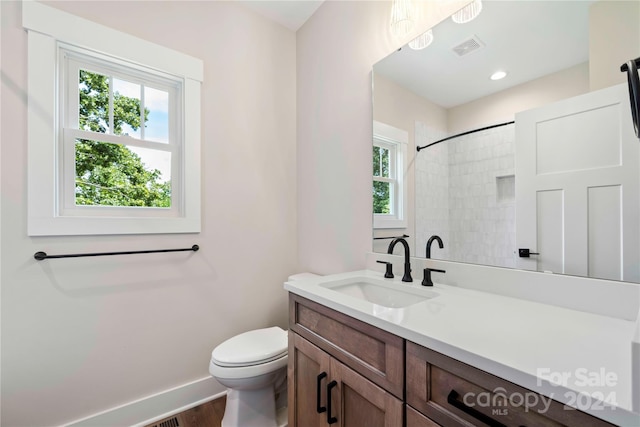 bathroom featuring hardwood / wood-style floors, vanity, and toilet