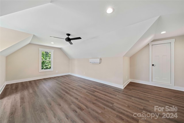 bonus room featuring ceiling fan, dark hardwood / wood-style flooring, lofted ceiling, and a wall mounted AC