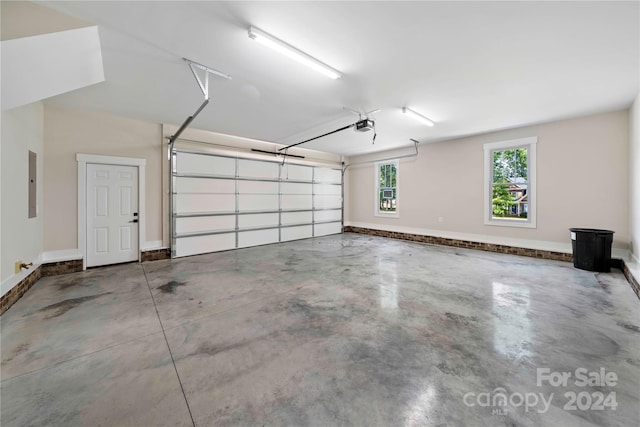 garage featuring electric panel and a garage door opener