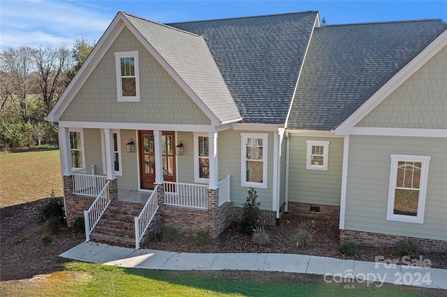 craftsman-style house featuring a porch and a front yard