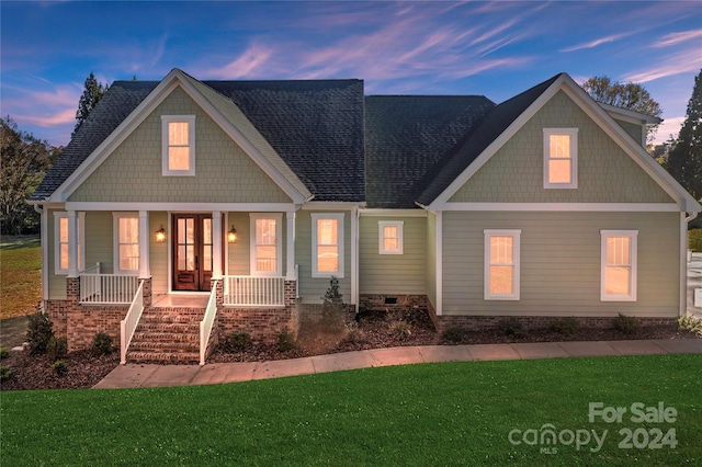 craftsman-style house featuring a yard and covered porch