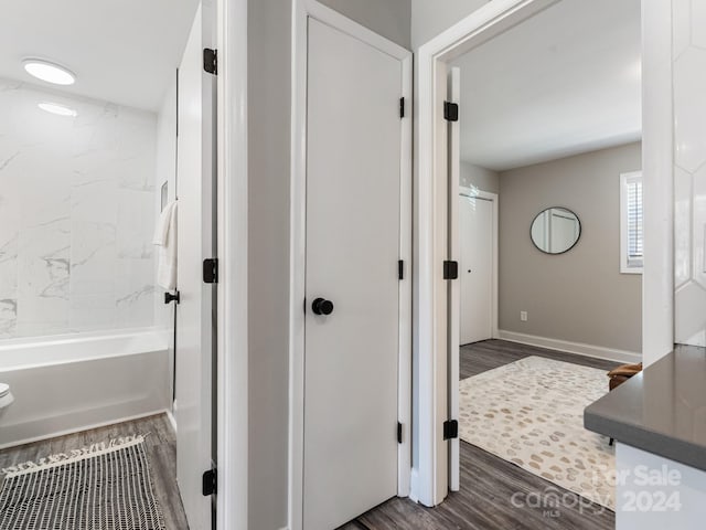 bathroom featuring hardwood / wood-style floors and tiled shower / bath