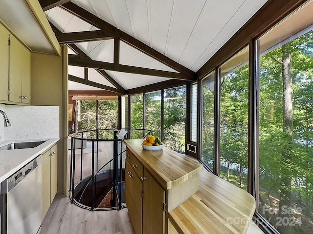 sunroom with lofted ceiling with beams and sink