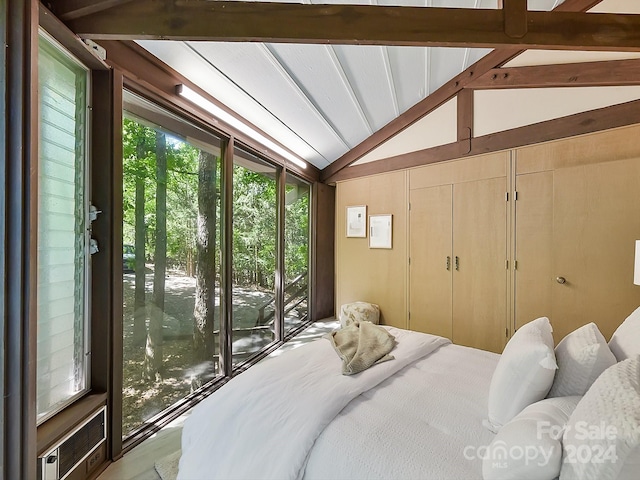 bedroom with lofted ceiling with beams, wooden walls, and access to exterior