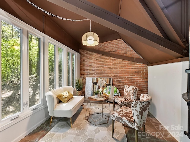 sunroom / solarium featuring vaulted ceiling with beams