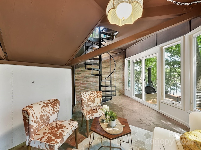 sunroom featuring lofted ceiling with beams