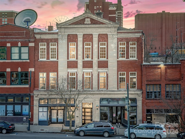 view of outdoor building at dusk