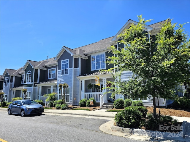 townhome / multi-family property with covered porch