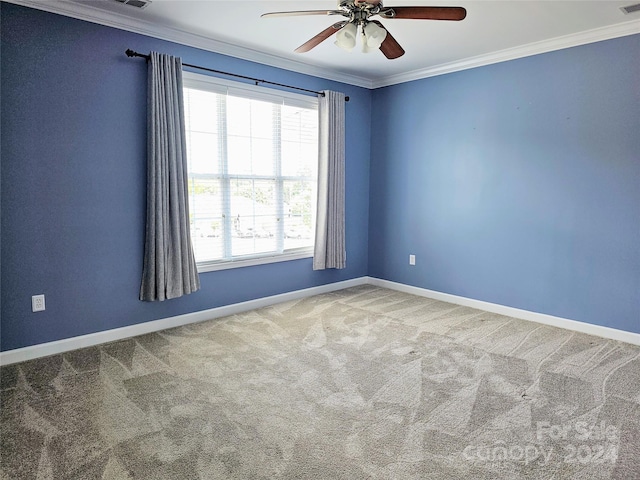 carpeted spare room with ornamental molding and ceiling fan