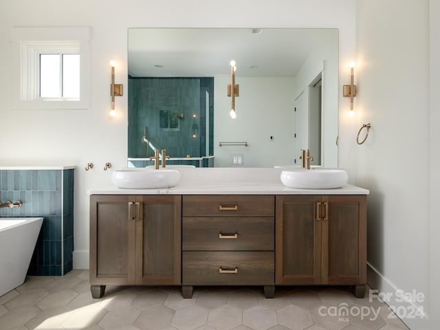 bathroom featuring a bath, tile walls, vanity, and tile patterned floors