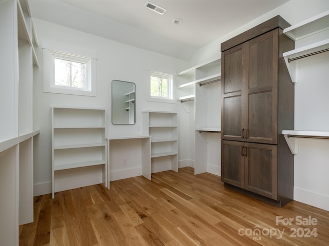 spacious closet with light hardwood / wood-style floors