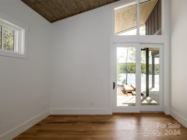 doorway with wood ceiling, lofted ceiling, french doors, and hardwood / wood-style flooring