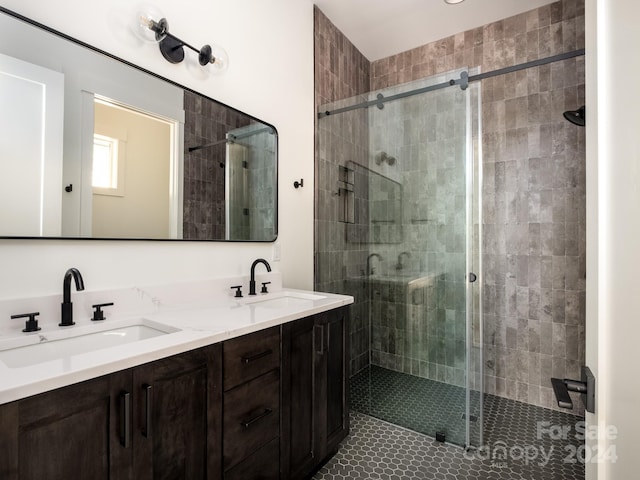 bathroom featuring vanity, tile patterned flooring, and a shower with door