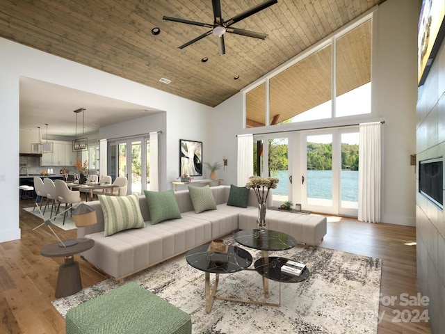 living room with high vaulted ceiling, ceiling fan, a healthy amount of sunlight, and french doors