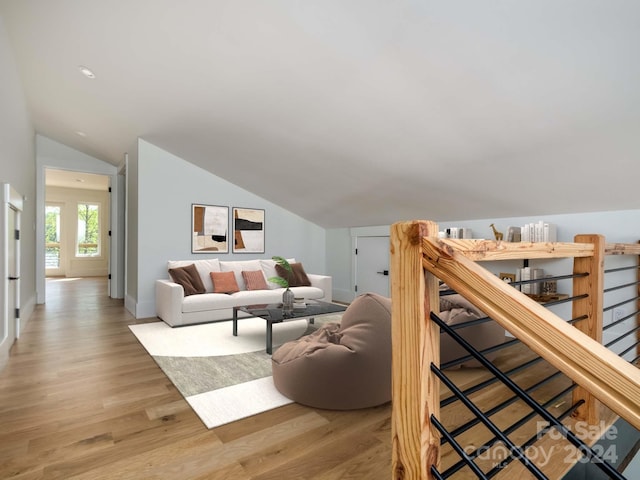 living room with lofted ceiling and light wood-type flooring