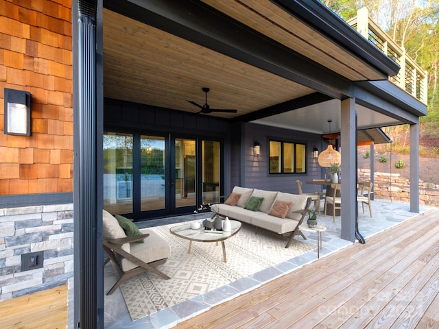 deck featuring ceiling fan and an outdoor living space