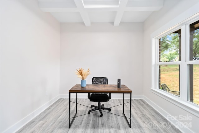 home office with light hardwood / wood-style flooring, beam ceiling, and a healthy amount of sunlight