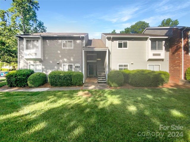 rear view of property with a yard