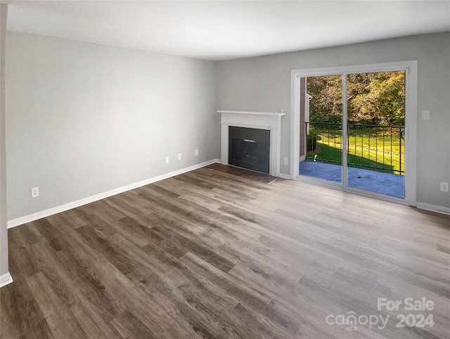 unfurnished living room with hardwood / wood-style flooring