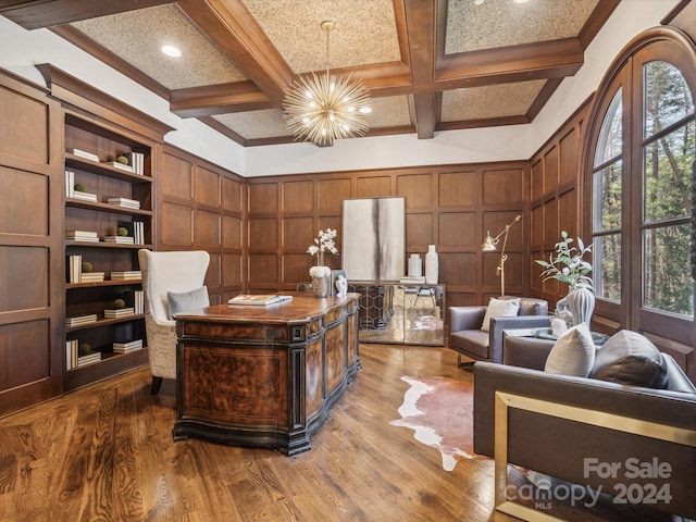 office space featuring beamed ceiling, hardwood / wood-style floors, an inviting chandelier, and coffered ceiling