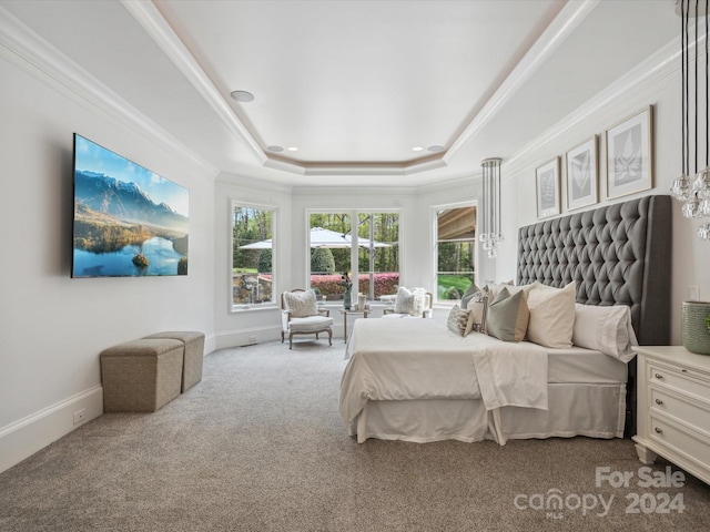 bedroom featuring carpet floors, crown molding, and a tray ceiling