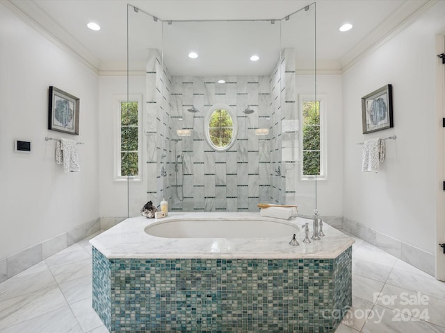 bathroom featuring plenty of natural light, tile floors, and tiled bath