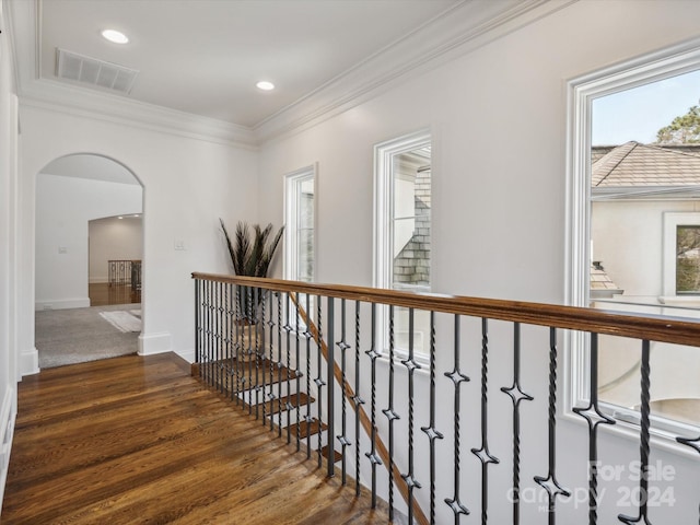 corridor with ornamental molding and dark hardwood / wood-style flooring