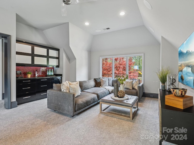 carpeted living room featuring high vaulted ceiling