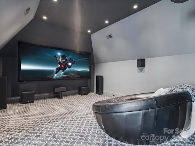 carpeted home theater with vaulted ceiling