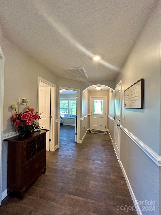 interior space with dark hardwood / wood-style flooring and a textured ceiling