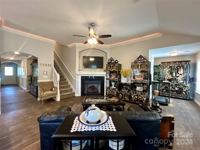 living room featuring hardwood / wood-style flooring, crown molding, ceiling fan, and lofted ceiling