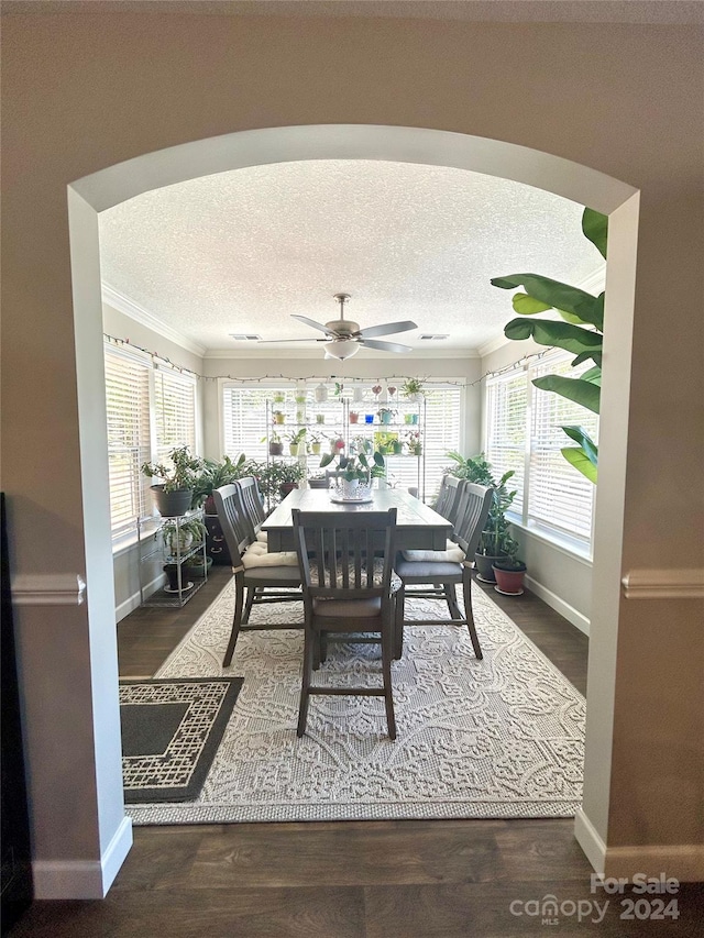 dining area with ornamental molding, ceiling fan, hardwood / wood-style flooring, and a textured ceiling