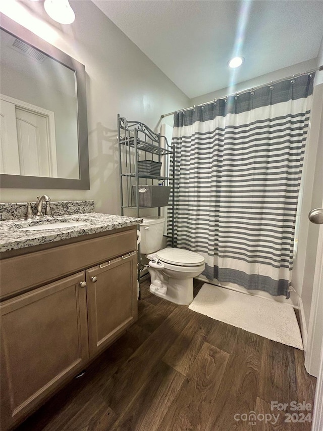 bathroom featuring wood-type flooring, vanity, and toilet