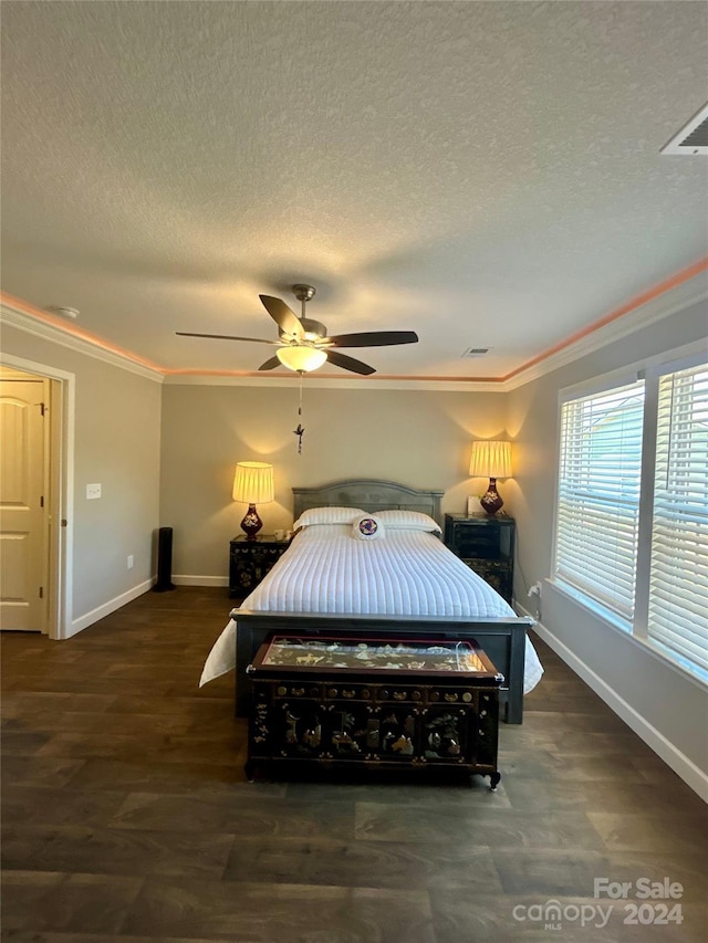 bedroom with ornamental molding, dark wood-type flooring, ceiling fan, and a textured ceiling