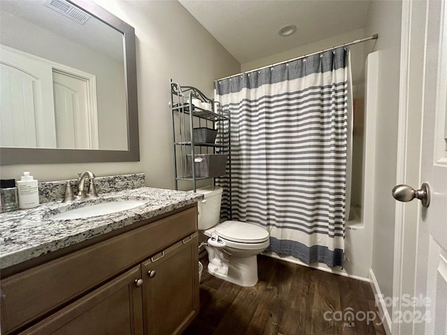 bathroom featuring wood-type flooring, vanity, and toilet