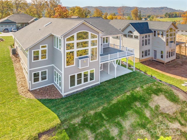 back of house with a patio and a lawn