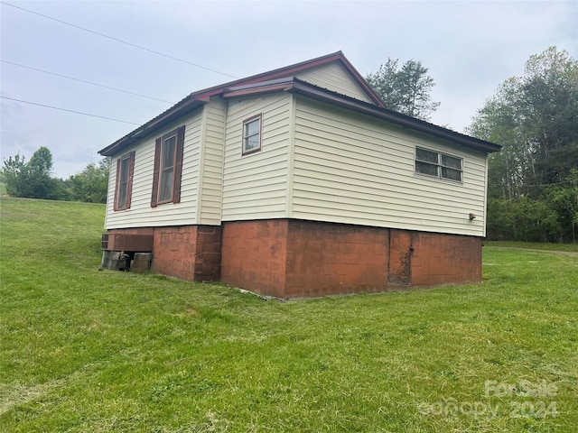 view of home's exterior with a lawn