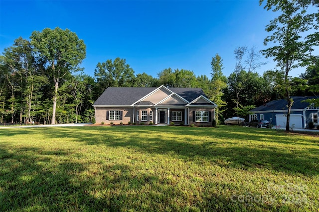 single story home featuring a garage and a front yard