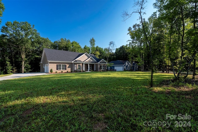 ranch-style house featuring a garage and a front lawn