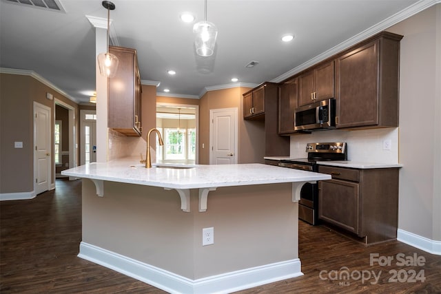 kitchen featuring tasteful backsplash, dark wood-type flooring, light stone countertops, appliances with stainless steel finishes, and sink