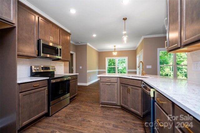 kitchen featuring decorative light fixtures, stainless steel appliances, light stone countertops, backsplash, and dark wood-type flooring